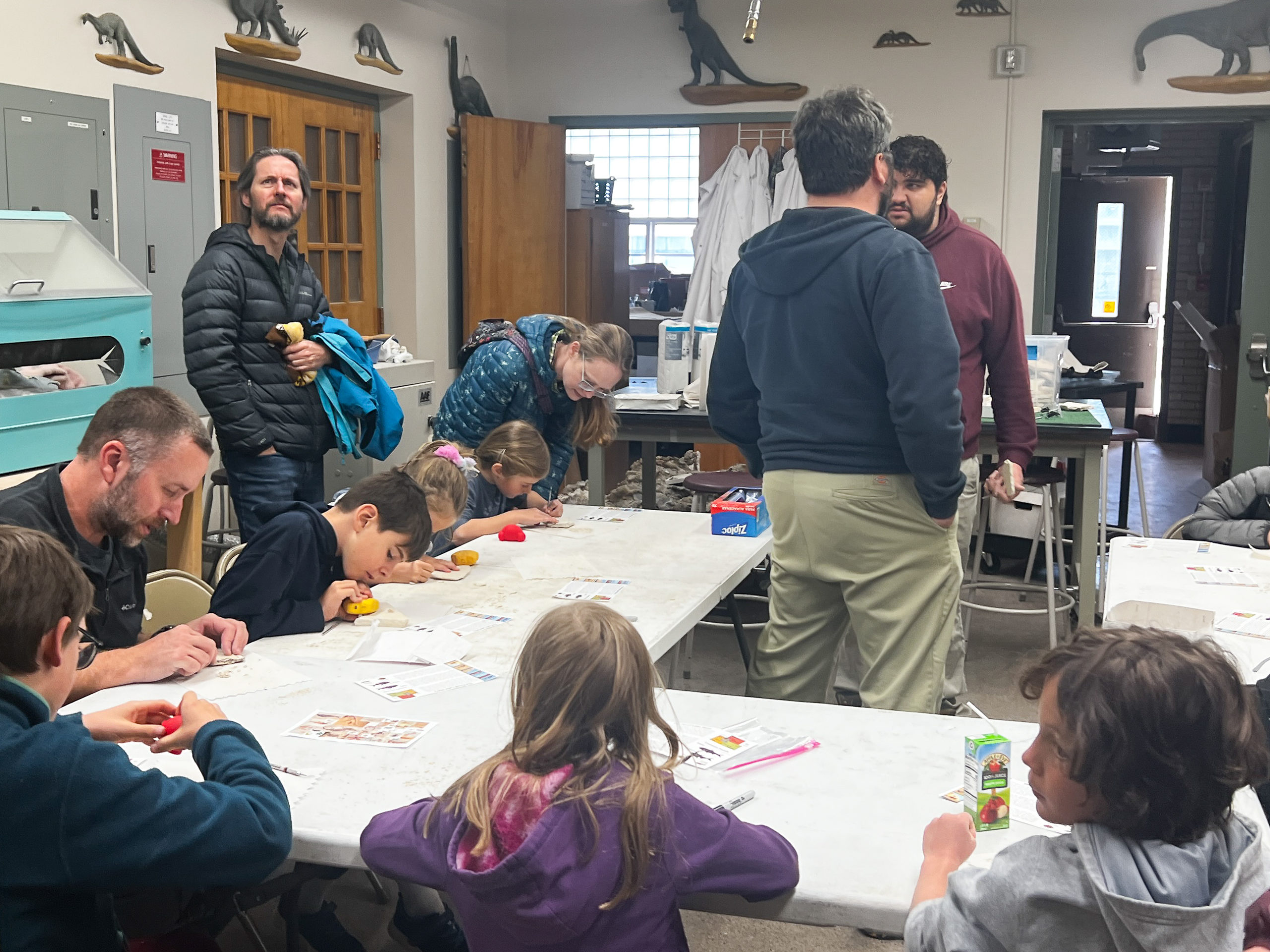 Attendees gather to learn about fossil formation through hands-on activities. (William Galloway Photo)